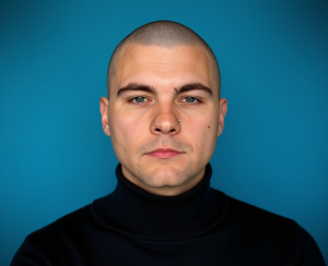 Grey Newell wearing the AWS golden jacket awarded to those who earn all twelve AWS Certifications